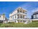 Elegant three-story home with columns and balconies at 1549 Corolla Ct, Reunion, FL 34747