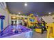 Game room with air hockey, racing games, and other arcade games at 1549 Corolla Ct, Reunion, FL 34747