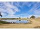Scenic view of a tranquil pond reflecting the sky and homes at 1549 Corolla Ct, Reunion, FL 34747