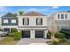 Two-car garage and manicured lawn at 1549 Corolla Ct, Reunion, FL 34747