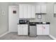 White kitchenette with black countertops and appliances at 1549 Corolla Ct, Reunion, FL 34747