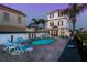 Inviting pool area with lounge chairs and a fire pit at 1549 Corolla Ct, Reunion, FL 34747