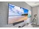 Close-up of large TV mounted on accent wall at 1549 Corolla Ct, Reunion, FL 34747