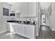Modern wet bar with white cabinets and granite countertop at 1549 Corolla Ct, Reunion, FL 34747