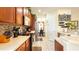 Modern kitchen boasting ample counter space, wood cabinets, and tiled floors at 16036 River Pointe Ct, Orlando, FL 32828