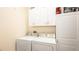 Convenient laundry room with washer, dryer, and cabinets at 16036 River Pointe Ct, Orlando, FL 32828