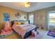 Cozy bedroom with a double bed and large windows at 16583 Cedar Crest Dr, Orlando, FL 32828