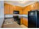 Kitchen with wood cabinets, black appliances, and granite countertops at 16583 Cedar Crest Dr, Orlando, FL 32828