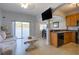 Living room with kitchen, neutral color walls and a beige couch at 16583 Cedar Crest Dr, Orlando, FL 32828