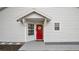 Red front door entry with a gray walkway and stone accents at 1659 Rivers Edge Dr, Orlando, FL 32825