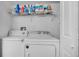 Laundry room with washer, dryer, and shelving for storage at 1659 Rivers Edge Dr, Orlando, FL 32825