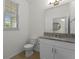 Clean bathroom with white cabinets, granite countertop, and toilet at 17066 Water Spring Blvd, Winter Garden, FL 34787