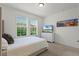 Bedroom with plush bed, large windows, and carpeted floor at 17066 Water Spring Blvd, Winter Garden, FL 34787