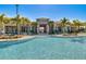 Inviting community pool with palm trees and lounge chairs at 17066 Water Spring Blvd, Winter Garden, FL 34787