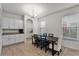 Bright dining room with table and chairs, granite counters, and white cabinets at 17066 Water Spring Blvd, Winter Garden, FL 34787