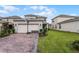 Two-car garage with basketball hoop and paved driveway at 17066 Water Spring Blvd, Winter Garden, FL 34787