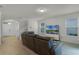 Living room with brown leather sectional sofa and large TV at 17066 Water Spring Blvd, Winter Garden, FL 34787