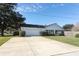 House exterior featuring a white brick facade and a two-car garage at 2201 Sunderland Rd, Maitland, FL 32751