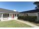 Front view of a house with a red door and white exterior at 2201 Sunderland Rd, Maitland, FL 32751