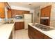 View of kitchen with stovetop, microwave, and refrigerator at 2201 Sunderland Rd, Maitland, FL 32751