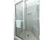 Large shower with tiled walls and seat at 2201 Sunderland Rd, Maitland, FL 32751