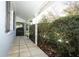 Side porch with tiled floor and lush greenery at 2201 Sunderland Rd, Maitland, FL 32751