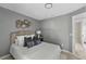 Bright bedroom with gray walls, comfortable bed, and natural light at 2471 E 20Th St, Sanford, FL 32771