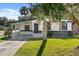 Updated home with modern facade, carport, and well-manicured lawn at 2471 E 20Th St, Sanford, FL 32771