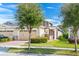 Inviting exterior with a manicured lawn, trees, and neutral stucco with stone accents at 2507 Yellow Brick Rd, St Cloud, FL 34772