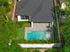 Aerial view of home and backyard pool with privacy fence and mature landscaping at 2510 Amherst Ave, Orlando, FL 32804