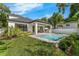 Landscaped backyard showcasing a pristine pool, patio with grill, and well-maintained lawn at 2510 Amherst Ave, Orlando, FL 32804