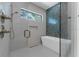 Modern bathroom featuring a sleek glass shower, soaking tub, and stylish tile accents at 2510 Amherst Ave, Orlando, FL 32804