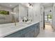Bathroom featuring double sinks, marble countertops, gold fixtures, and a glass-enclosed shower at 2510 Amherst Ave, Orlando, FL 32804
