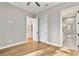 Bright bedroom with hardwood floors featuring doorways to closet and bathroom at 2510 Amherst Ave, Orlando, FL 32804