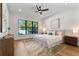 Bright bedroom featuring a ceiling fan, a large window, and a modern, neutral-toned decor at 2510 Amherst Ave, Orlando, FL 32804