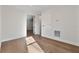 Neutral bedroom with hardwood floors, white trim, and an open doorway at 2510 Amherst Ave, Orlando, FL 32804
