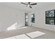 Bedroom featuring carpet flooring, ceiling fan and two windows for natural light at 2510 Amherst Ave, Orlando, FL 32804