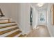 Entryway featuring hardwood floors, stairs, and a front door with glass panels at 2510 Amherst Ave, Orlando, FL 32804