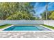 Inviting rectangular pool with a gray stone patio and white fence at 2510 Amherst Ave, Orlando, FL 32804