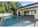 A gorgeous pool and patio area complement this modern home, with easy access from inside at 2510 Amherst Ave, Orlando, FL 32804