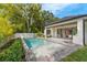 Inviting backyard oasis with a sparkling pool, lush landscaping, and seamless indoor-outdoor transition at 2510 Amherst Ave, Orlando, FL 32804