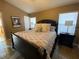 King-size bed in a well-lit bedroom with wood floors at 2564 Bear Creek Ct, Kissimmee, FL 34747