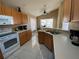 Kitchen with light wood cabinets and white appliances at 2564 Bear Creek Ct, Kissimmee, FL 34747