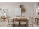 Dining area with modern light fixture and adjacent to kitchen and living room at 3168 Emerald Acres Ln, Sanford, FL 32771