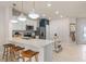 Modern kitchen with white cabinetry, quartz countertops and breakfast bar seating at 3168 Emerald Acres Ln, Sanford, FL 32771