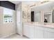 Double vanity bathroom with white cabinets, quartz countertops, and a large mirror at 3175 Emerald Acres Ln, Sanford, FL 32771