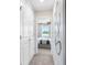 Hallway with carpet flooring, white doors, and a view into a bedroom at 3175 Emerald Acres Ln, Sanford, FL 32771