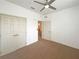 Bedroom with double door closet and ceiling fan at 3300 Whitestone Cir # 101, Kissimmee, FL 34741