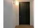 Apartment entryway with dark gray door and neutral colored walls at 3300 Whitestone Cir # 101, Kissimmee, FL 34741