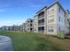 Exterior view of condo building with grassy area and walkway at 3300 Whitestone Cir # 101, Kissimmee, FL 34741